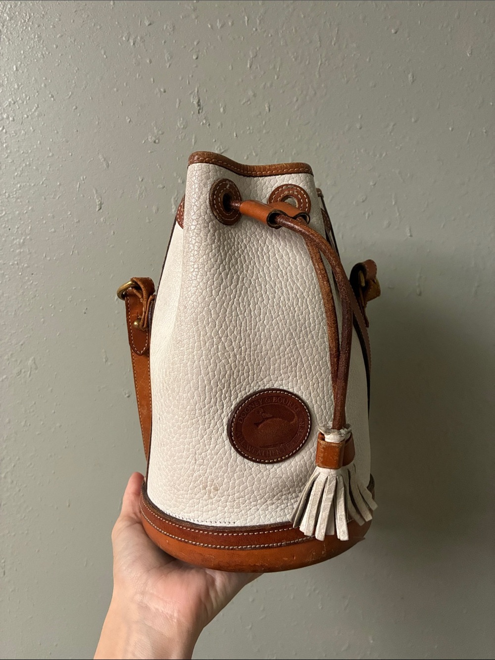 Dooney & Bourke Cream and Tan Pebble Leather Drawstring Bucket Bag with Tassel